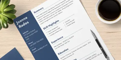 Lebenslauf der auf einem Tisch liegt und daneben eine kleine Pflanze und ein Kaffee